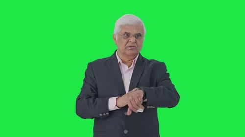 Indian senior manager waiting for someone Green screen