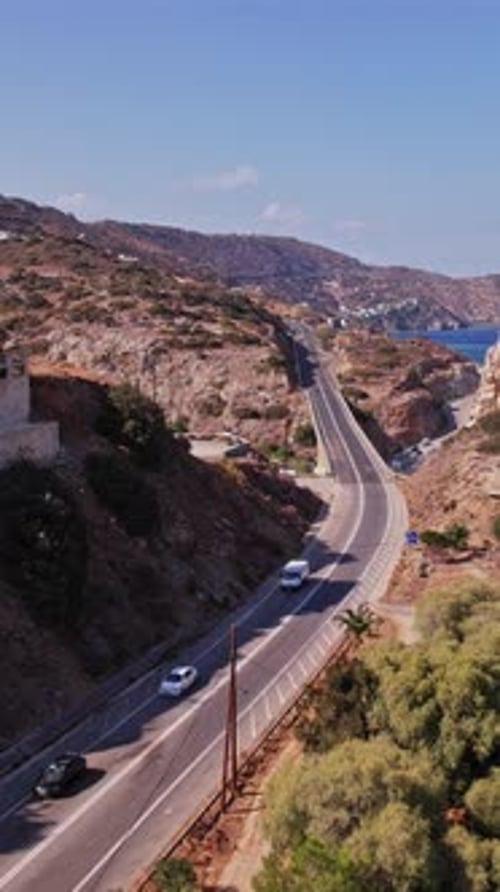 Scenic coastal road along cliffs with ocean view in bright daylight