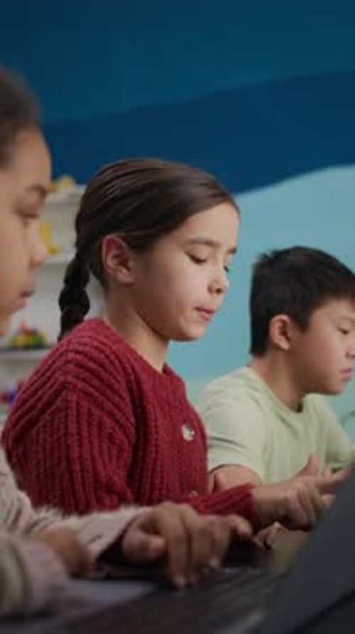 Children Collaborating on Computer in Classroom