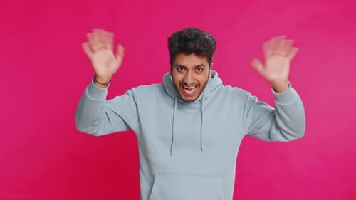 Cheerful Young Adult Waving and Smiling