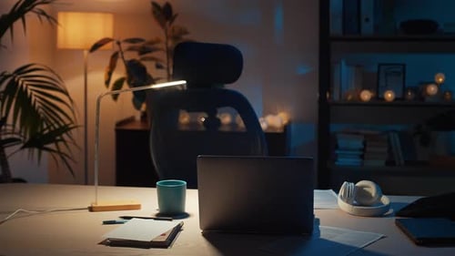 Home Office Desk at Night With Laptop and Lamp