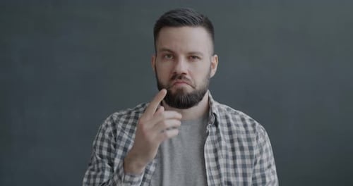 Slow Motion Portrait of Pensive Young Man Thinking Then Smiling Raising Finger Having Brilliant Idea