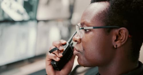 Security guard, radio and black man in control room, monitors and conversation for safety check