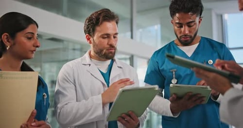 Doctor, tablet and nurse discussion in hospital for surgery schedule, test results or feedback