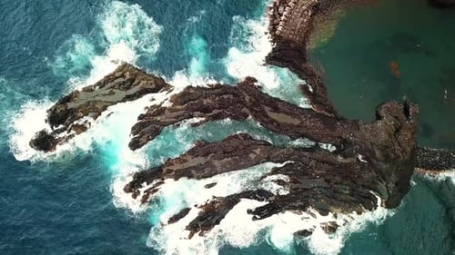 Top Down Aerial View Of Rugged Volcanic Rock Coastal Formations