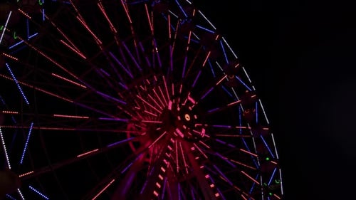 Glowing Ferris Wheel at Night in the City