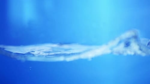 Crystal Droplet on a Smooth Water Surface. Photography of Liquid Purity.