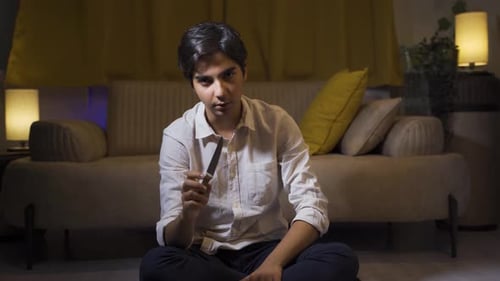 Psycho man holding the knife to the camera.