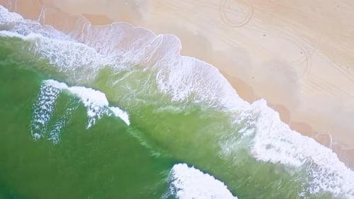 Aerial Top view of a transparent blue sea with beautiful waves at sunny day in summer. air of ocean