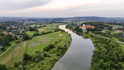 In the Distance on the Riverbank Atop a Hill Stands an Abbey