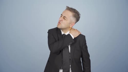 Man Massaging Sore Neck in Business Suit