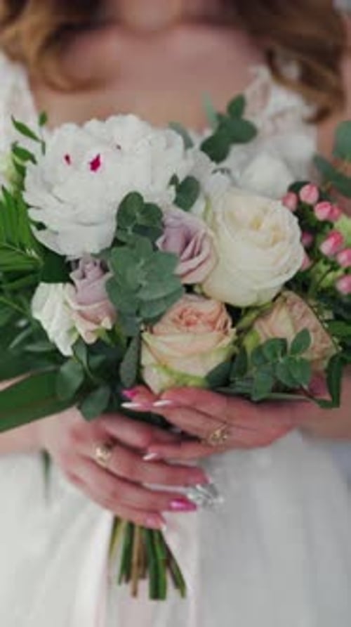 Woman Holding Bouquet in White Wedding Dress