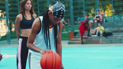 Energetic and Vibrant Youth Actively Engaged in Playing Basketball on a Bright Outdoor Court