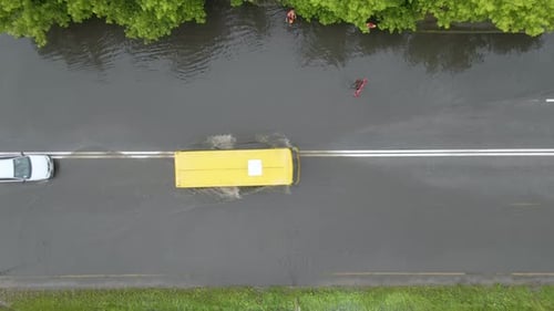 Aerial View of City Traffic with Cars Driving on Flooded Street After Heavy Rain