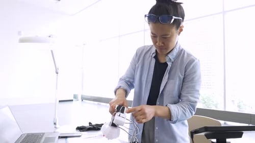 Female Engineer Assembling Robotics In Science Laboratory