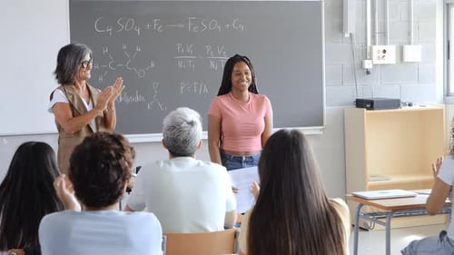 High School Class Applauding an African American Teen Girl After Her Presentation