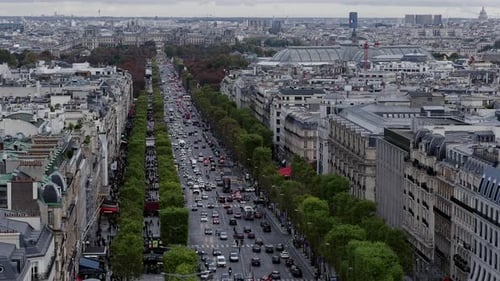 Aerial view looking down a busy Avenue des Champs-Elysee towards the Musee du Louvre, Paris, France.