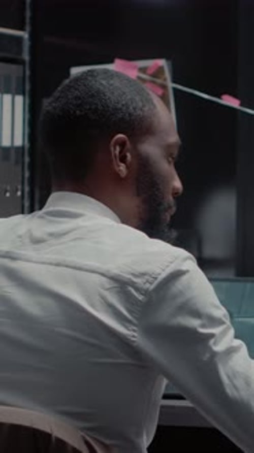 Man Working on Laptop in Modern Office