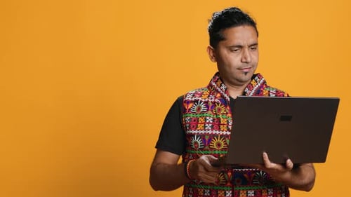 Man with Friends in Teleconference Meeting Using Laptop Studio Background
