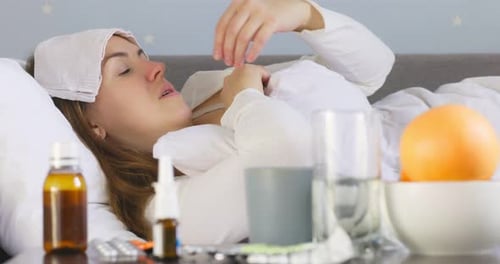 Young Woman Sick in Bed with Cold