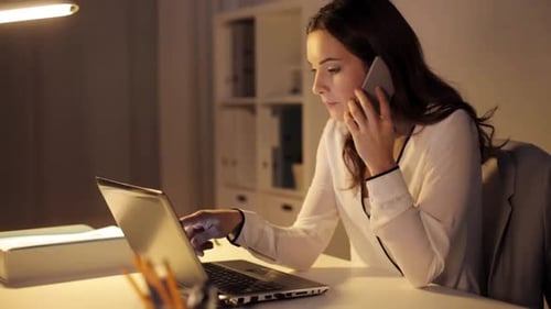 Woman working late at desk on laptop
