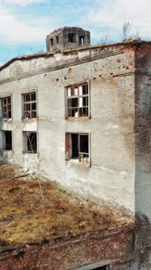 Aerial view of an old factory ruin and broken windows. Old industrial building for demolition.