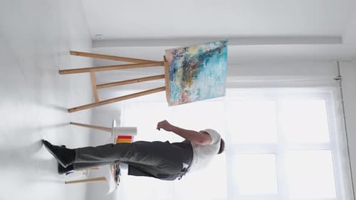 A Talented Artist Using a Brush Creates a Modern Masterpiece of Oil Painting on a White Canvas