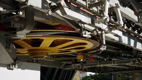 Large Wheel of Funicular Mechanism Spin and Gives Movement to Cabins with Tourists
