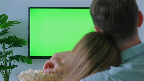 Couple Watching Television Together with Green Screen for
