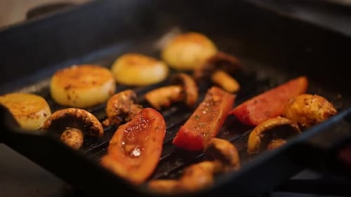 Vegetables Cooking in Sizzling Grill Pan on Stove