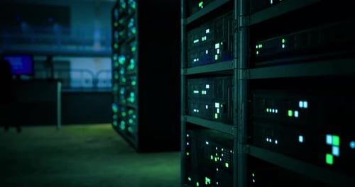 Illuminated Server Racks in a Dark Data Center During Late Night Hours