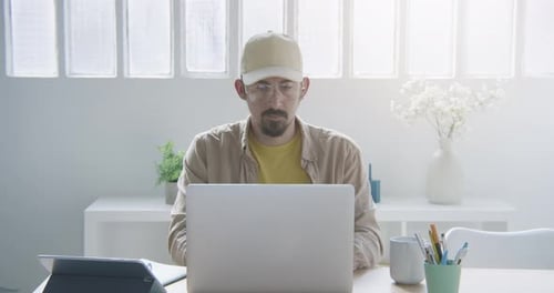 Man Typing on Laptop Computer at Desk Indoors