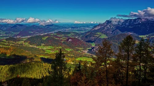 Mountainous Backdrop of a Scenic Landscape with Timelapse Clouds Overhead, Viewed from a Picturesque