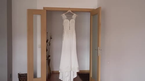 Elegant Wedding Dress Hanging in Doorway