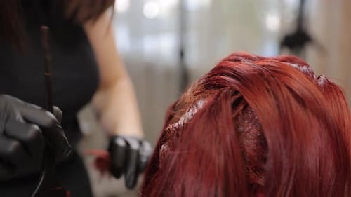 Applying Hair Color to a Woman's Red Hair