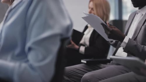 Adults Reviewing Documents at Conference