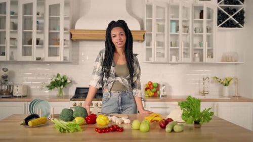 Woman with Vegetables in Bright Modern Kitchen