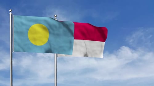 Palau and Indonesia National Flags Waving Against Blue Sky