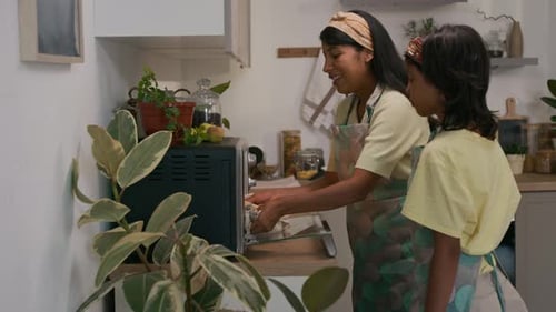 Mother and Child Baking in a Sunny Kitchen