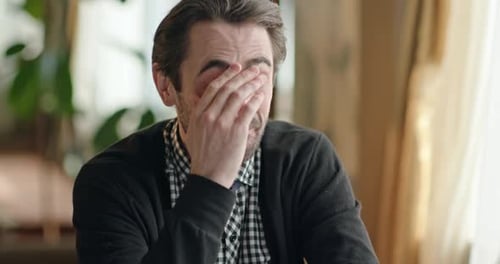 Emotional Man Laughing and Crying in an Office