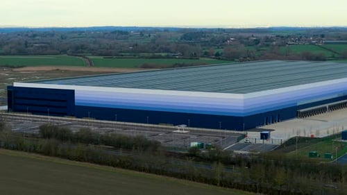Aerial View Showing Large Warehouse Complex Operating Logistics Operations in Rural Landscape Drone