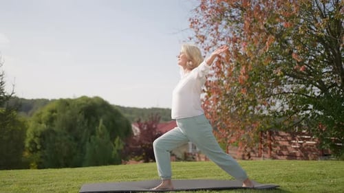 50s 60s Middle Aged Mature Old Senior Woman Meditation Yoga Balance Outdoors Nature Garden