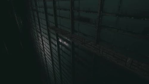 Tall Structure Illuminated By Light in a Dark Space at Night
