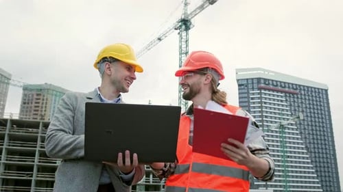 Team of Building Contractors Having Conversation During Site Inspection