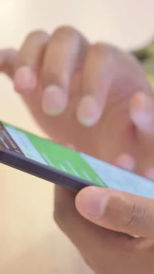 Close up of African Man Browsing, Scrolling Smartphone, Vertical Video