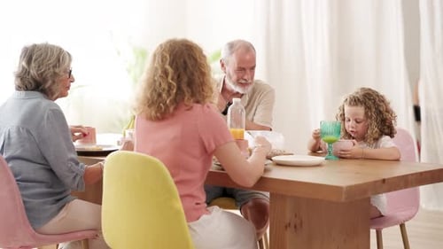 Multi-Generational Family Enjoying Meal Together at Home