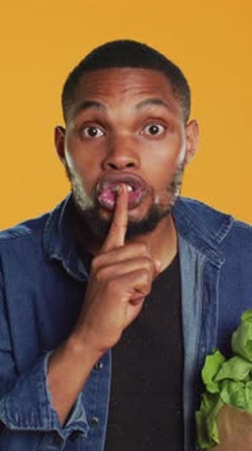 Vertical Video African American Secretive Guy Doing Mute Hush Gesture with Finger Over Lips