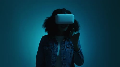 Woman Wearing VR Headset in Blue Lit Studio