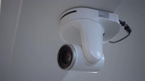 White Motorized Camera with Large Lens Closeup