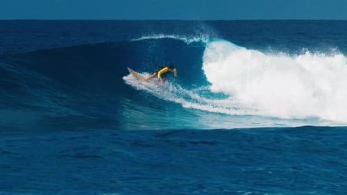Professional Surfer Rides Big Ocean Wave in the Maldives